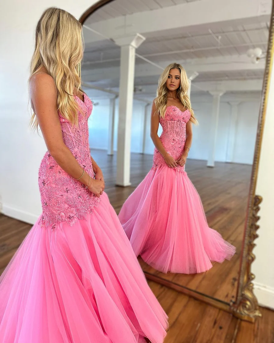 Back view of hot pink tulle prom gown with lace accents.