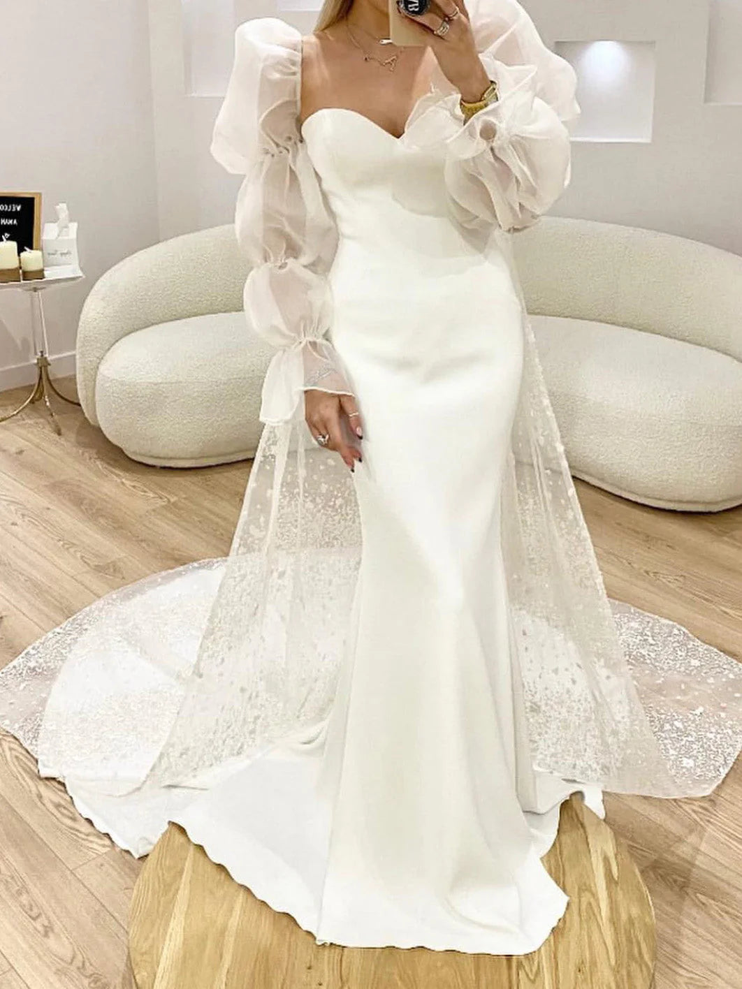 Elegant mermaid wedding dress with sweetheart neckline and intricate lace appliques.