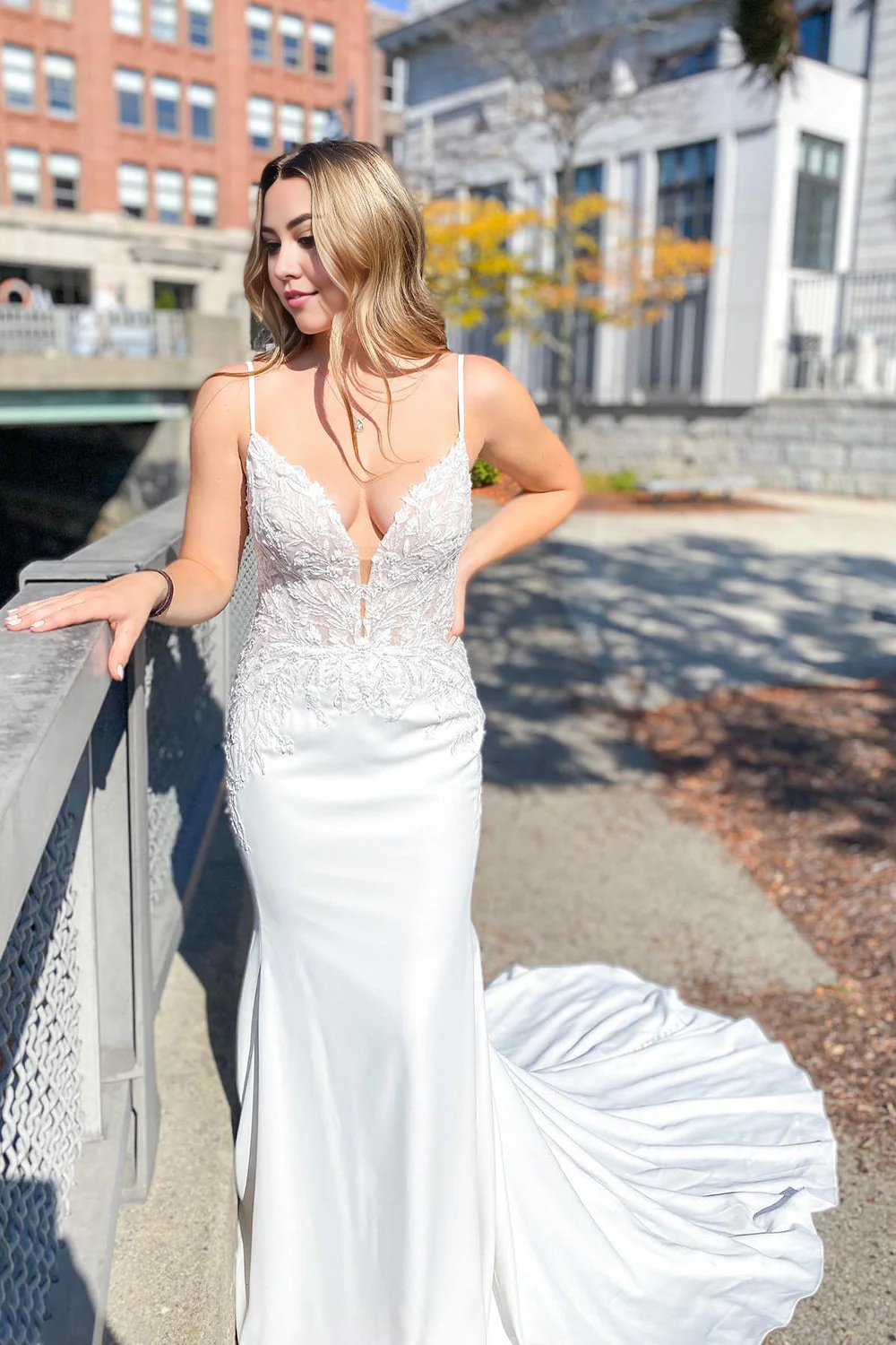Bride wearing an elegant mermaid sweetheart lace wedding dress with an open back.