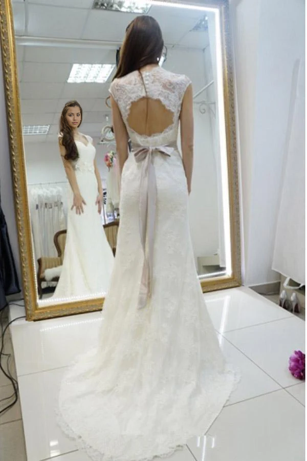 Back view of mermaid wedding dress featuring sashes and delicate lace details.