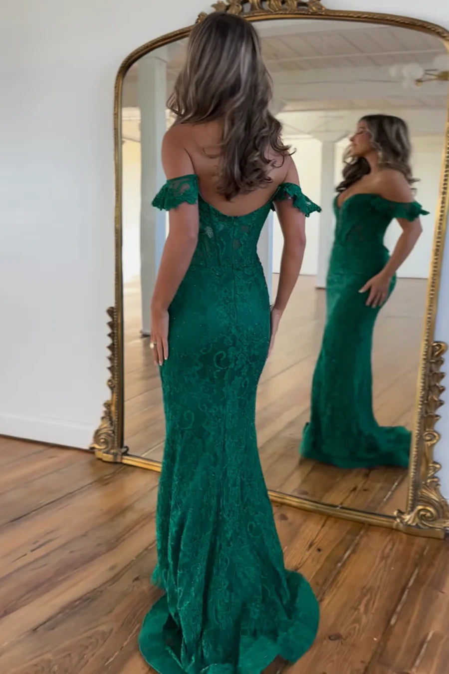Close-up of the dark green lace and beading on the mermaid evening gown.