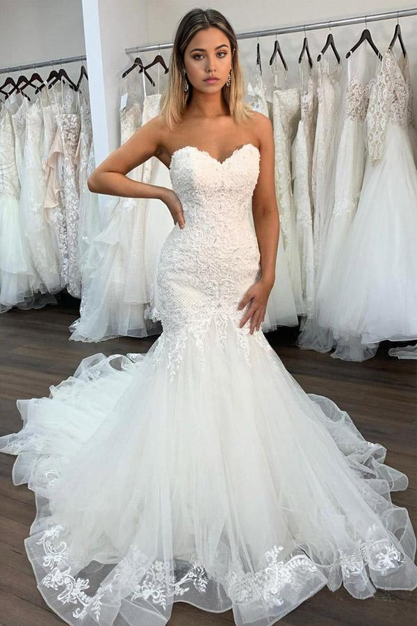 Mermaid wedding dress with sweetheart neckline and lace ruffles.
