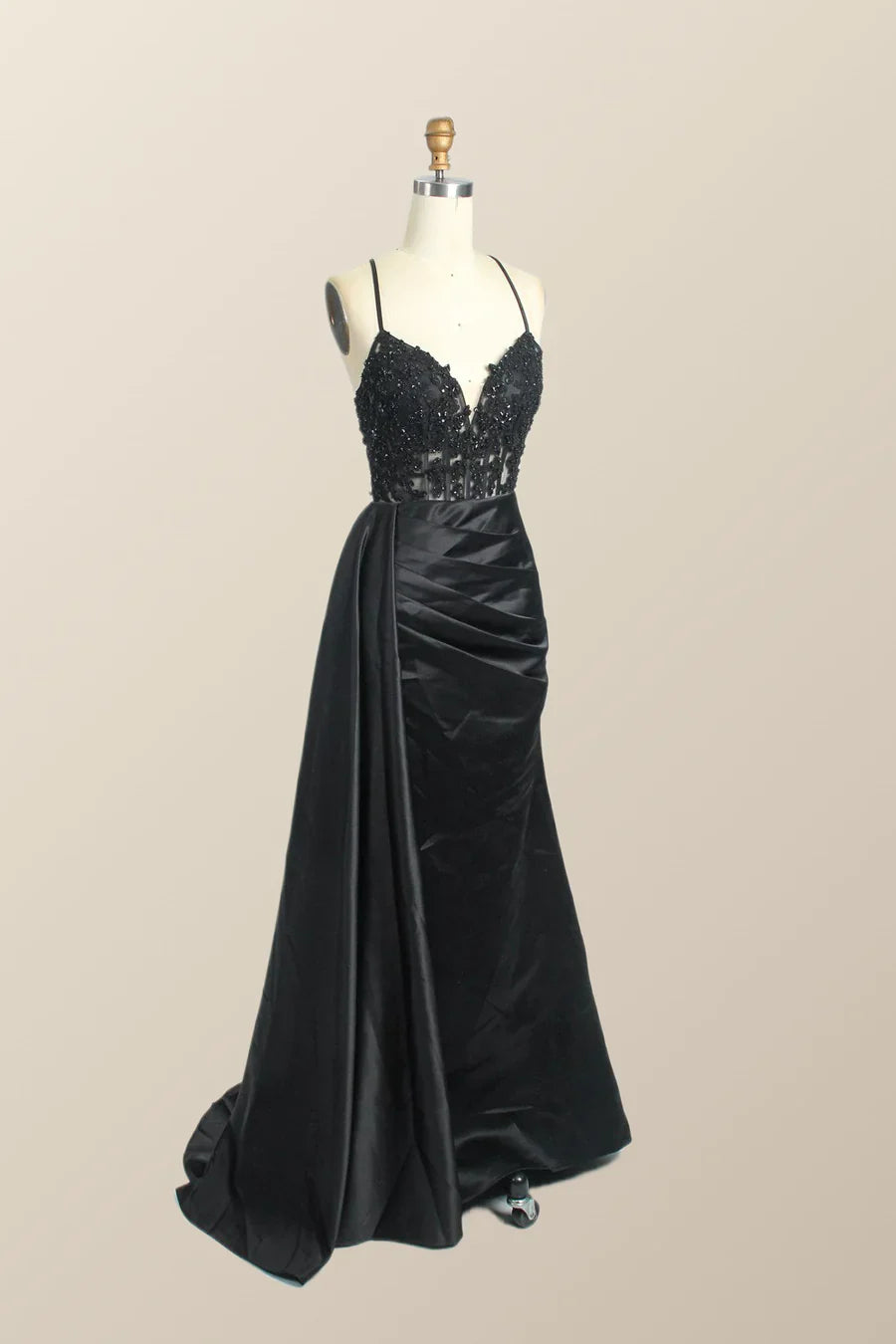 Back view of a red mermaid formal dress with a side slit.