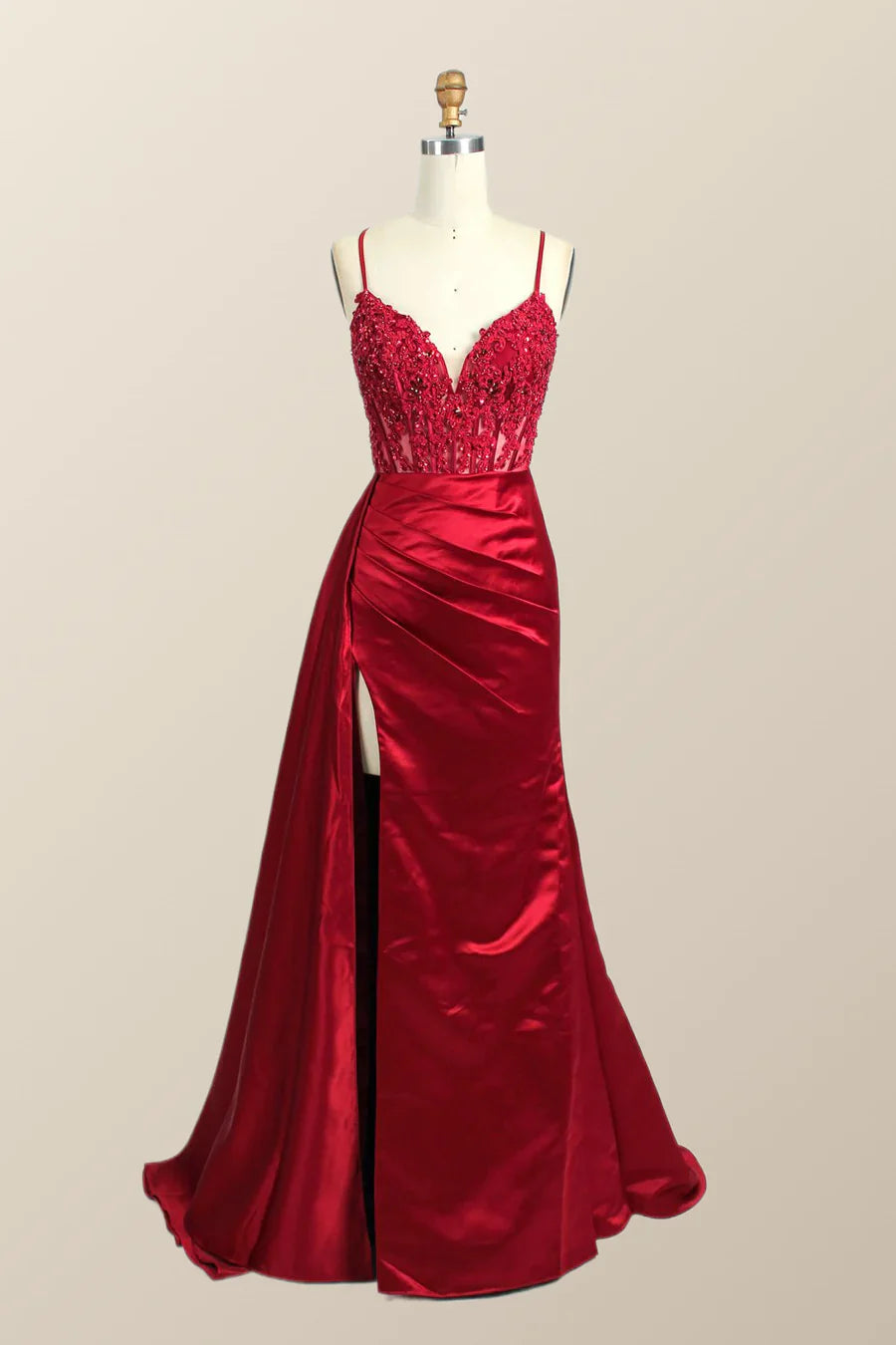 Side view of a woman in a red mermaid formal dress.