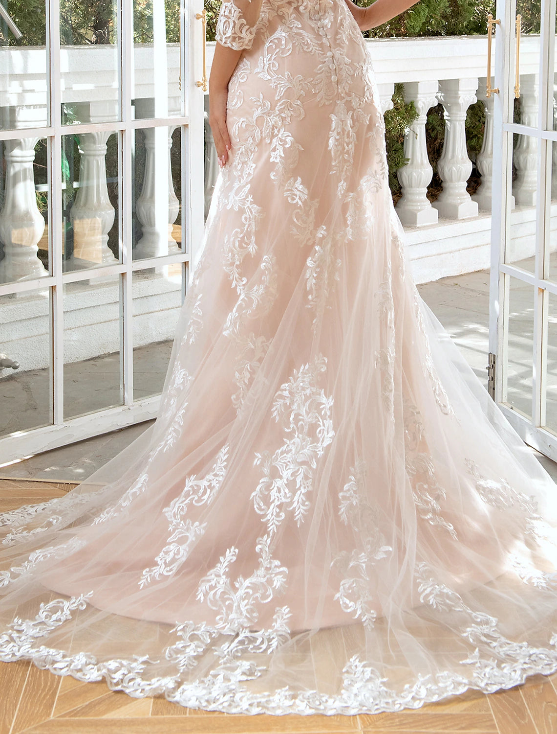 Side view of a sweetheart long sleeve lace wedding gown.