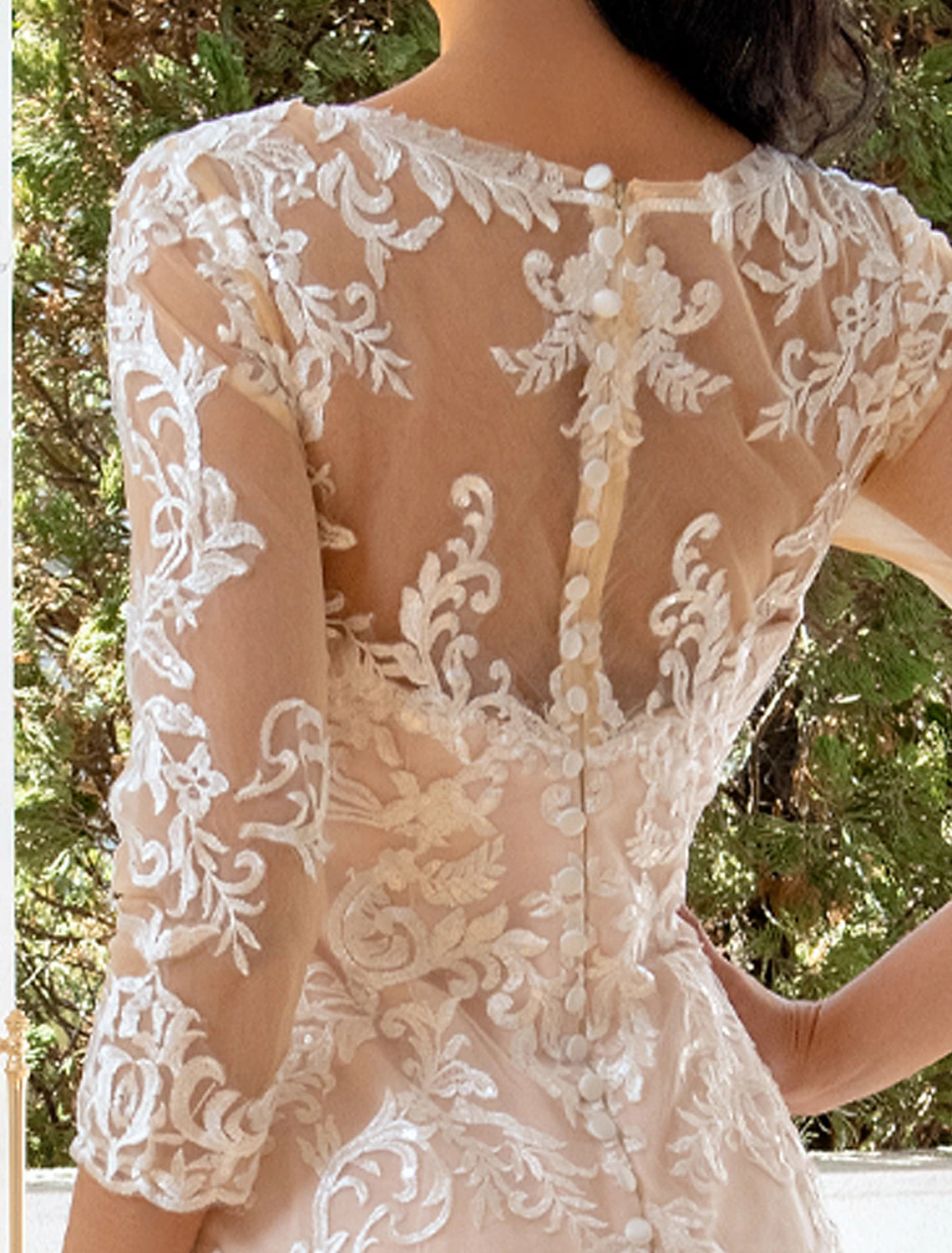 Detail of the sweep train and intricate appliques on a bridal dress.