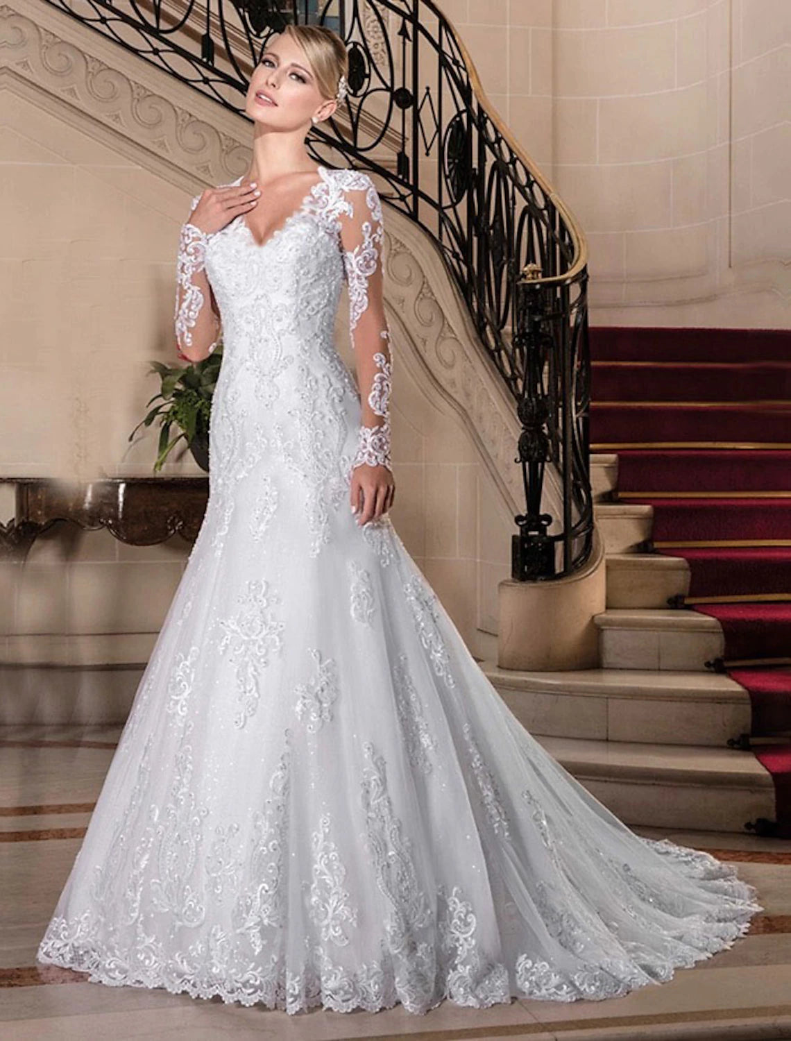 Elegant mermaid wedding gown with sweetheart neckline and long lace sleeves.