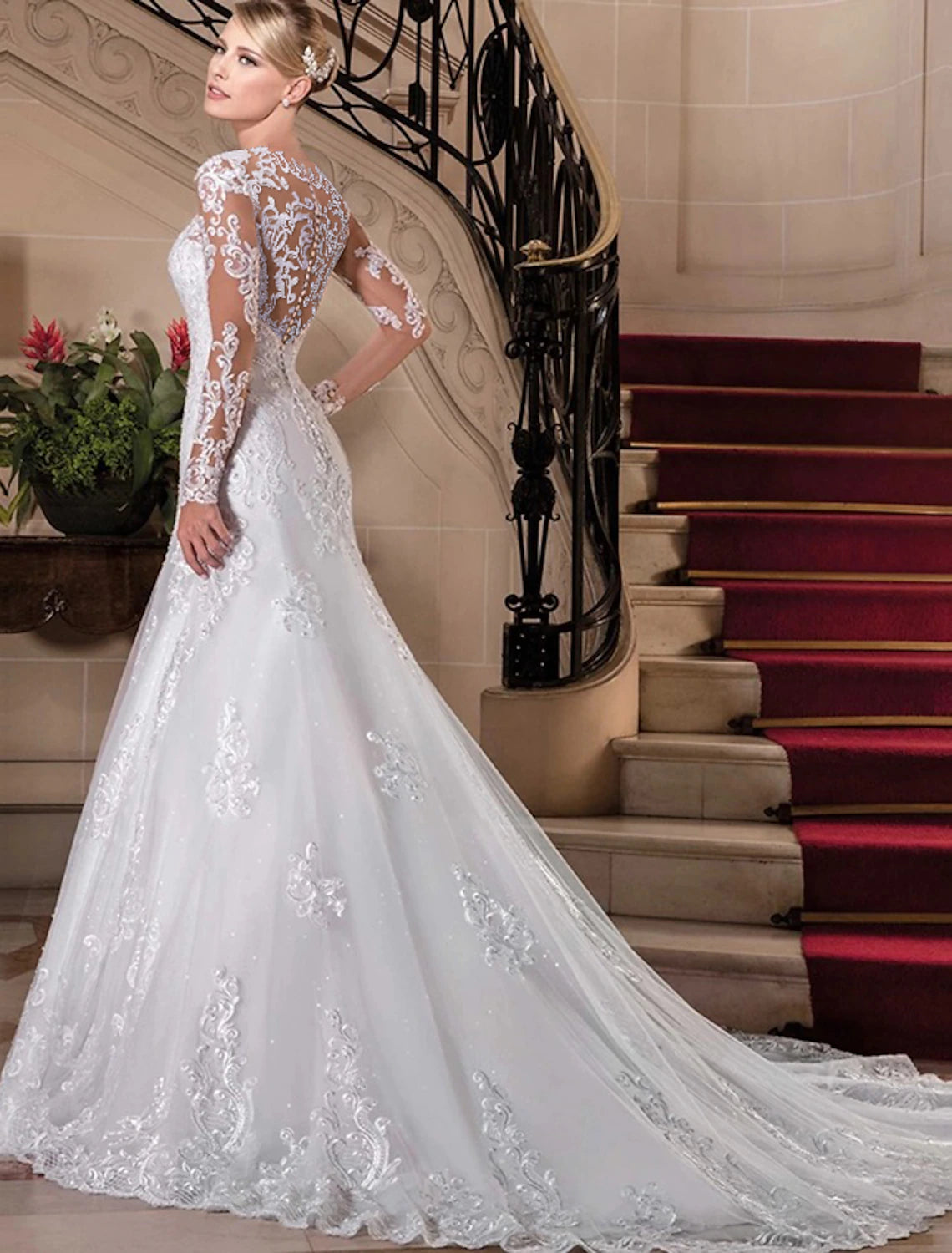 Close-up of intricate lace and beading on a bridal dress sleeve.