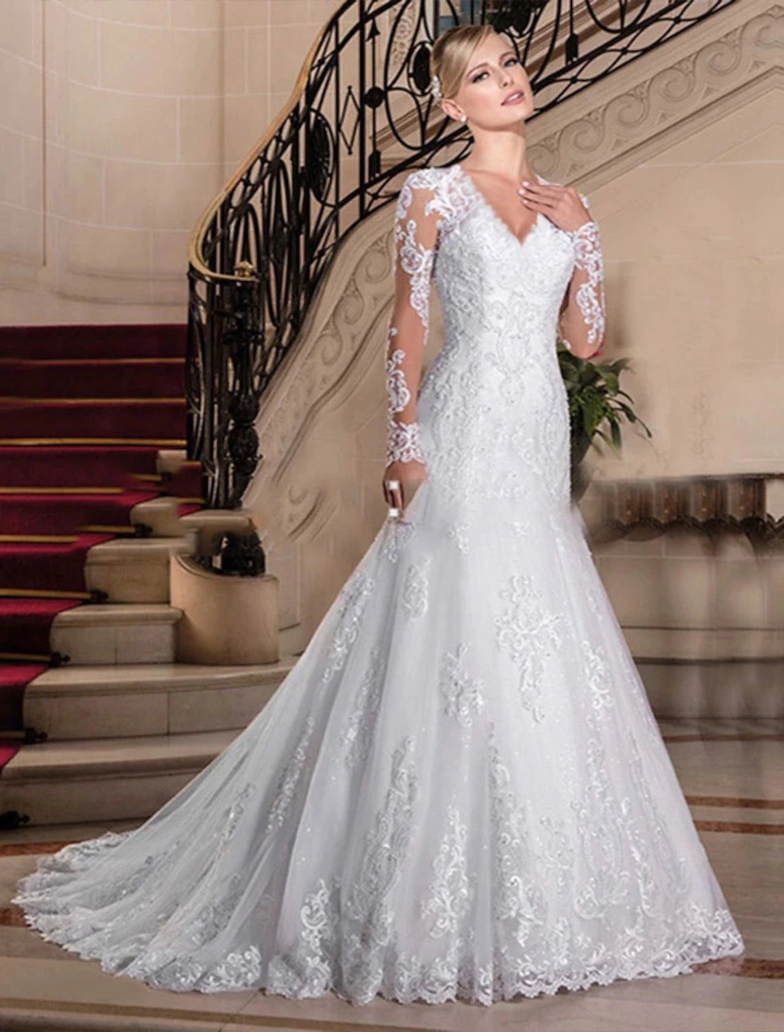Full length view of a formal bridal gown with long sleeves and beaded lace.