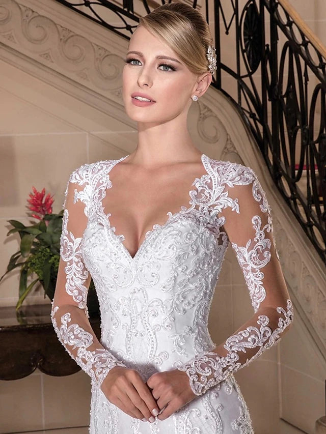 Side view of a bride wearing a mermaid formal wedding gown.