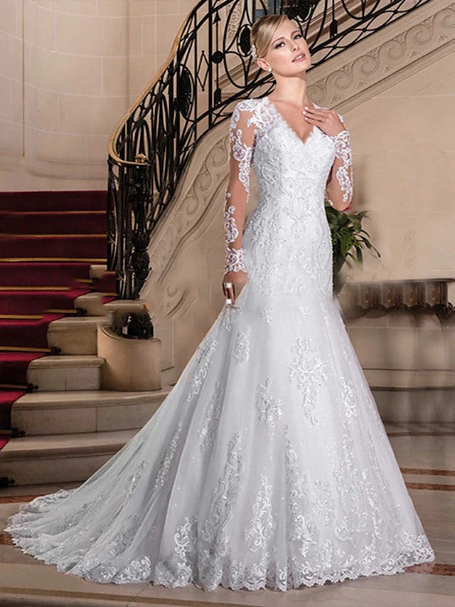 Full length view of a mermaid wedding dress with a court train.