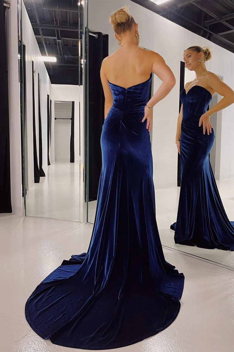 Side view of a navy velvet mermaid prom dress, highlighting the flattering silhouette and high slit.
