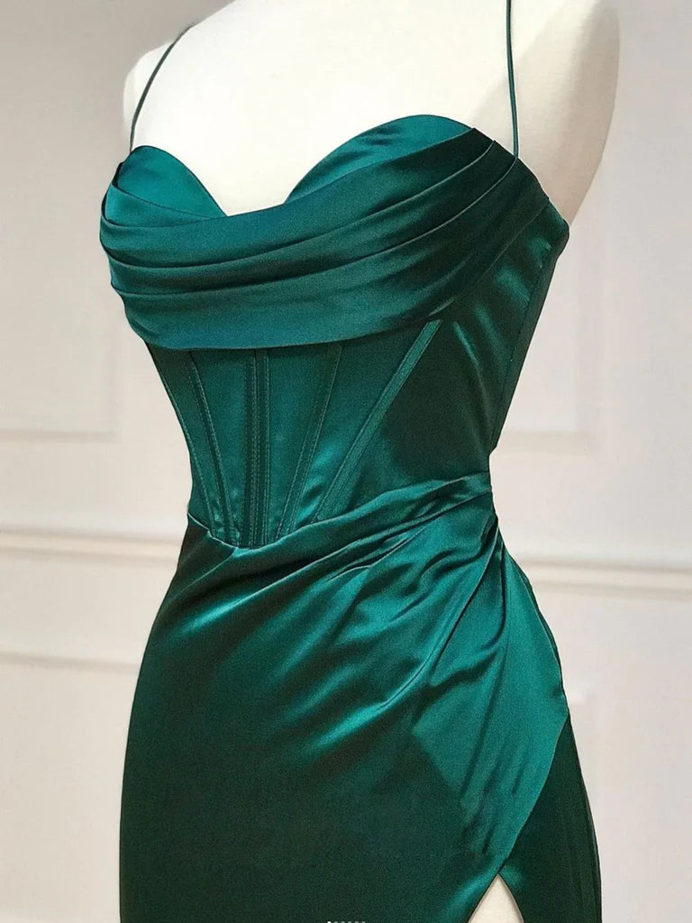 Side view of a woman posing in a long sweetheart prom dress.