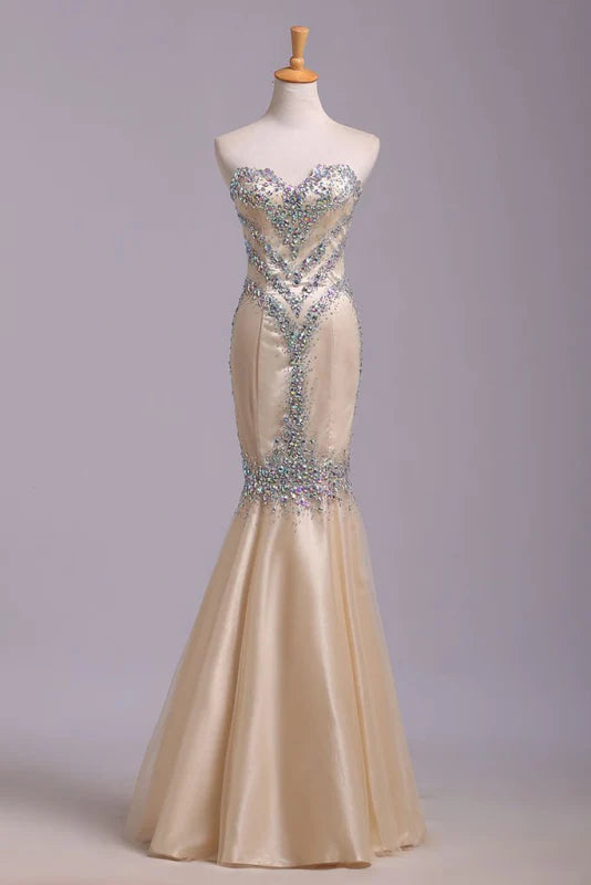 Woman wearing an elegant sequined mermaid prom dress.
