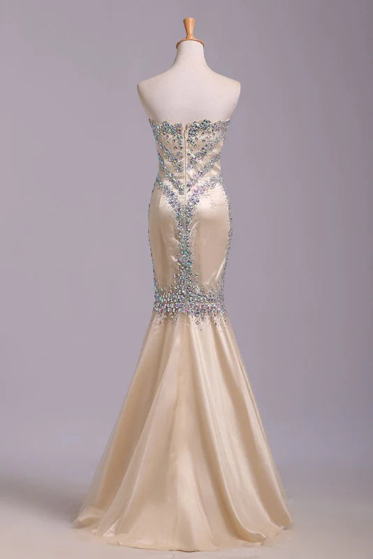 Back view of a woman in a sequined mermaid evening gown.