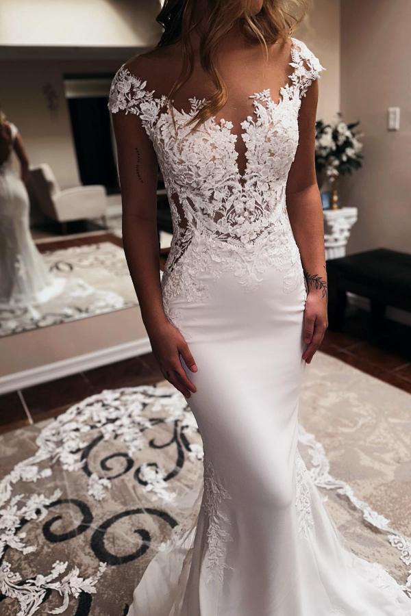 Elegant mermaid wedding dress with sweetheart neckline and chapel train.