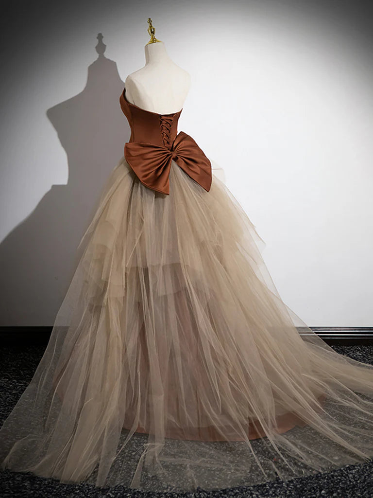Side view of a woman posing in a mermaid satin tulle long prom dress.