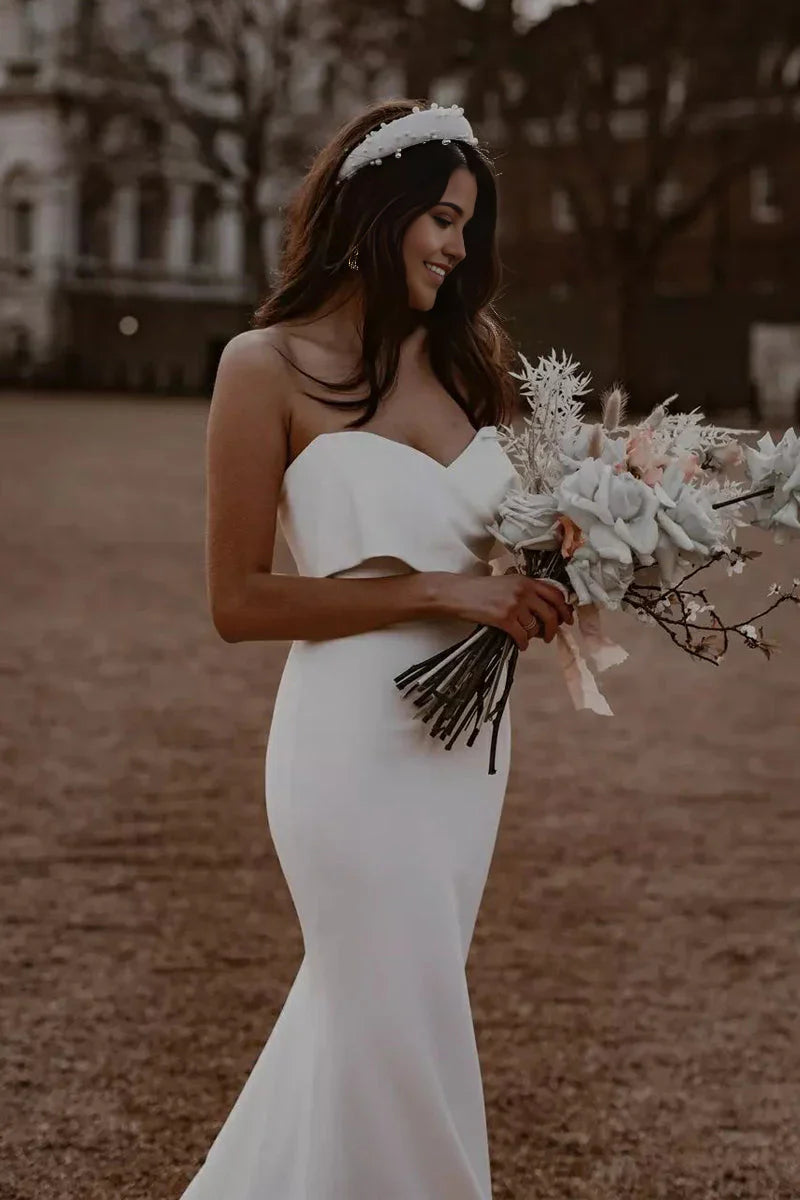 Elegant white mermaid wedding dress with sweetheart neckline.
