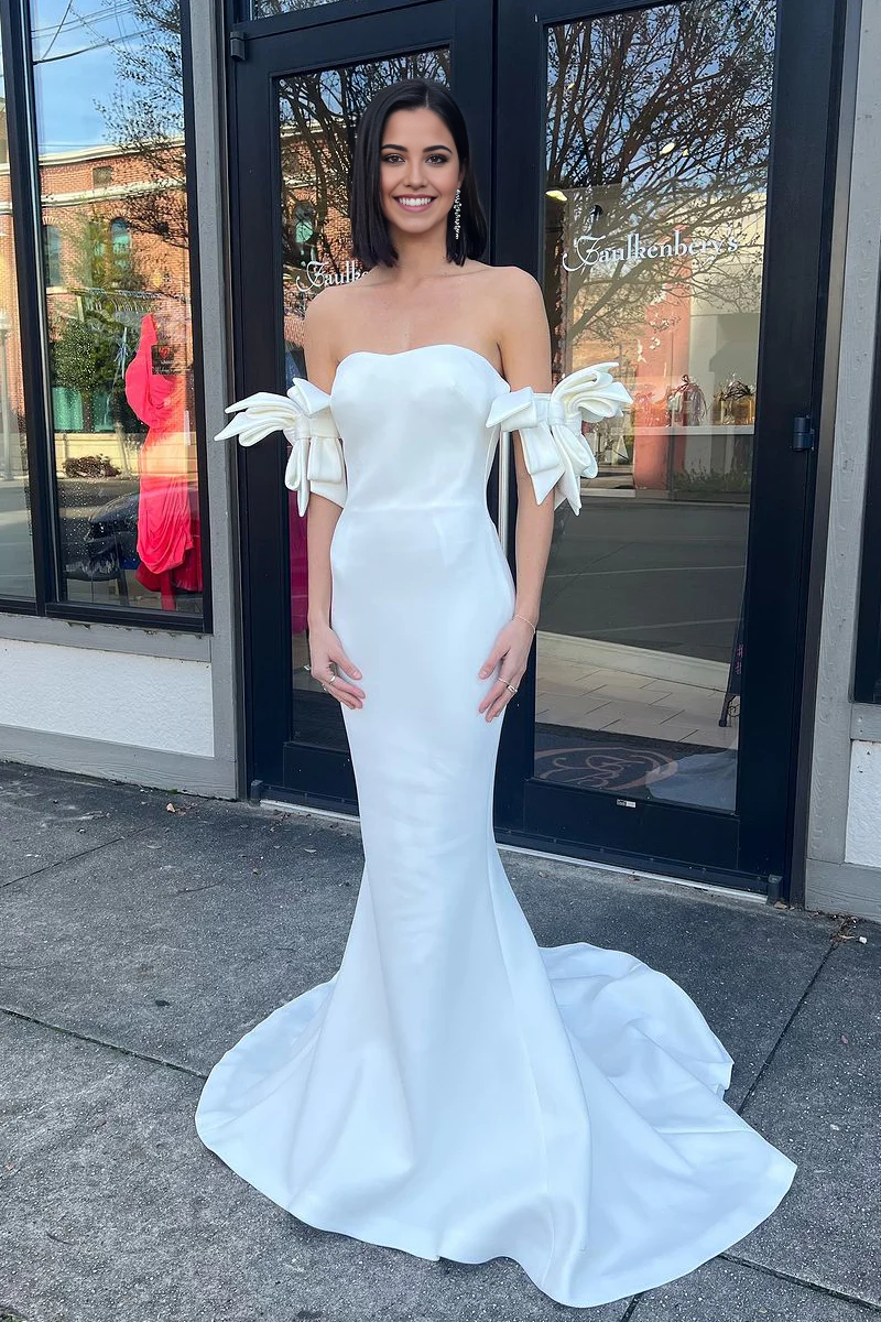 White satin mermaid prom dress with a sweetheart neckline and bow detail.