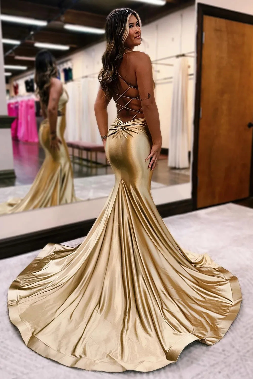 Back view of a mermaid prom dress showing lace-up detail.