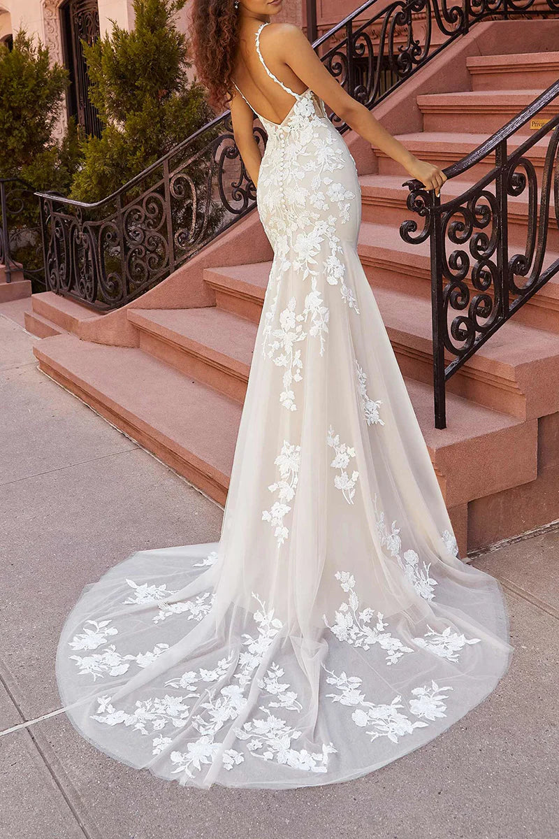 Back view of mermaid wedding dress showing court train and spaghetti straps.