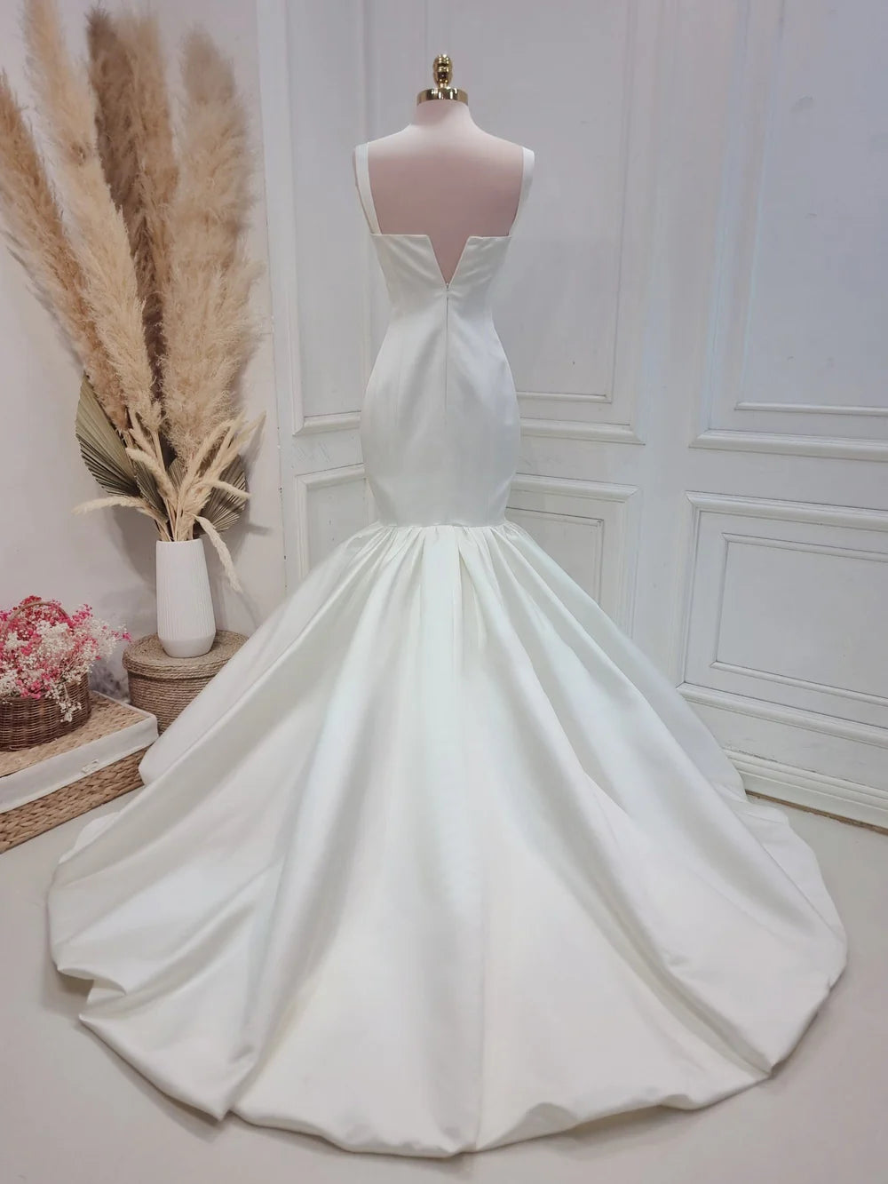 Back view of a floor-length strapless satin bridal gown.