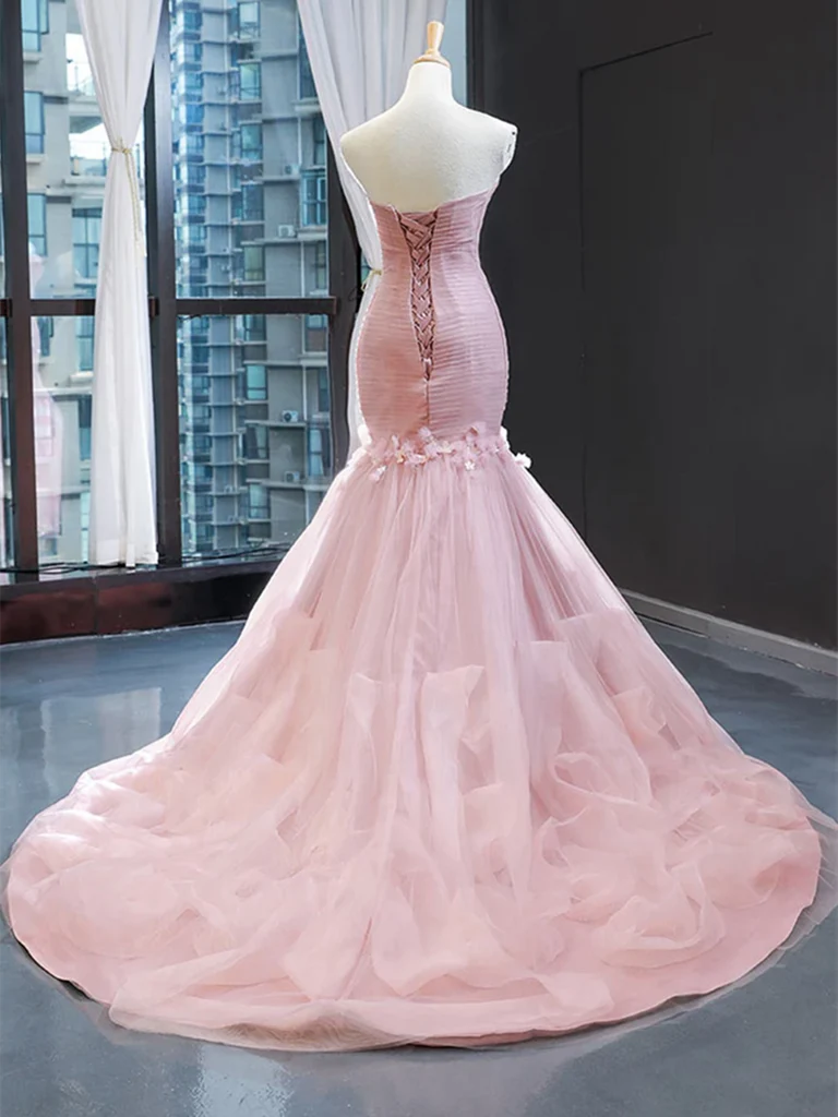 Side view of a long mermaid formal evening gown.