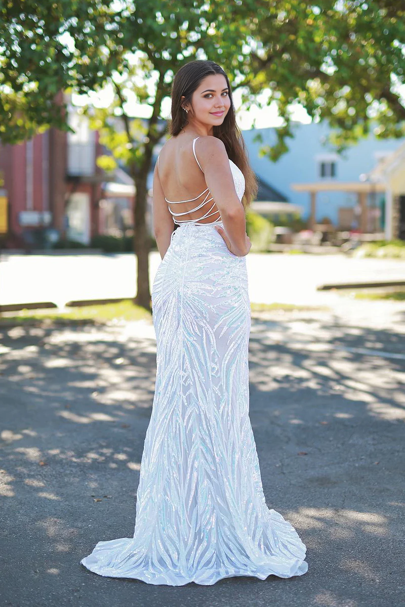 Full view of a woman wearing a shimmering white sequin mermaid gown.
