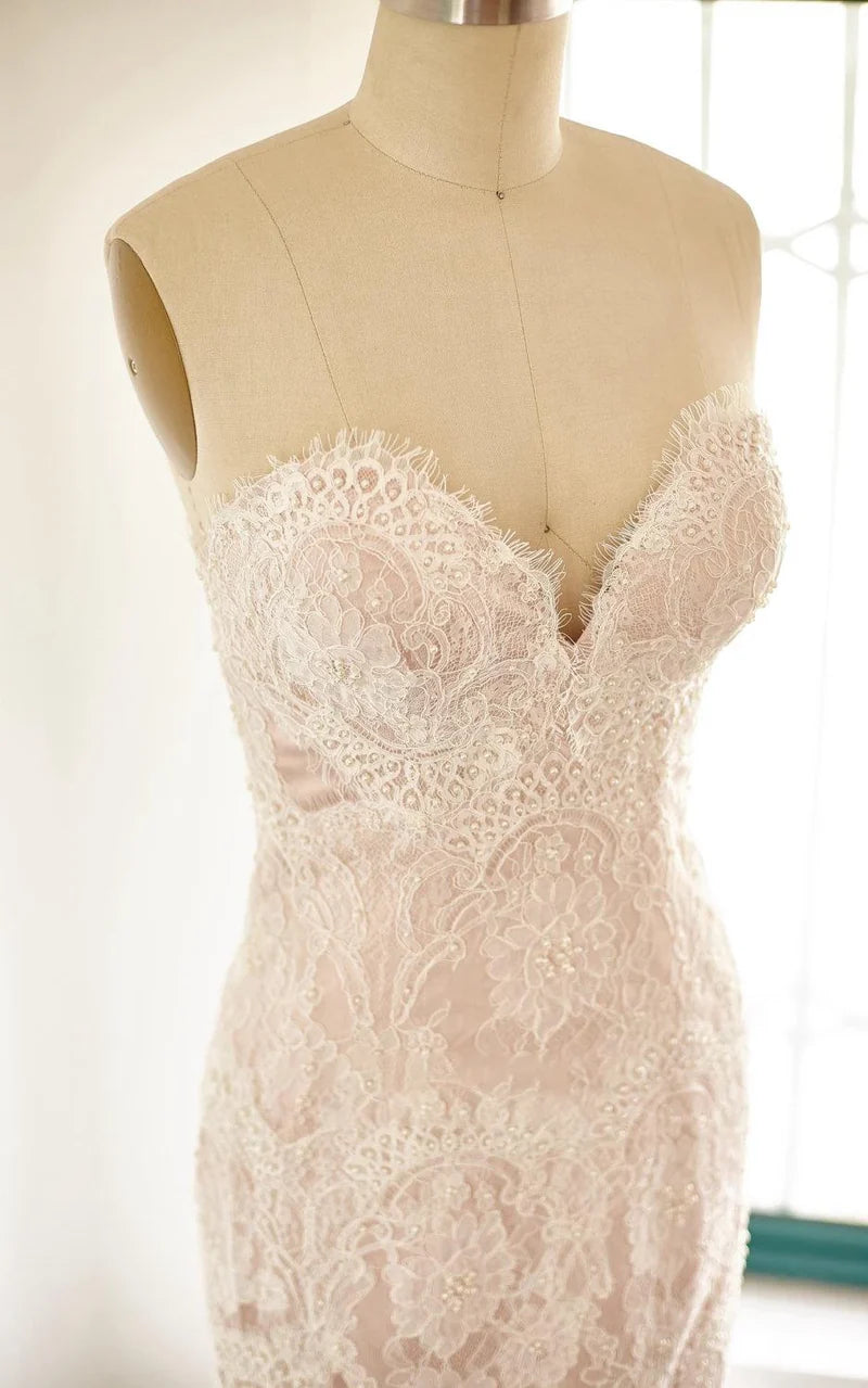 Back view of a mermaid formal dress showcasing lace and satin fabric.