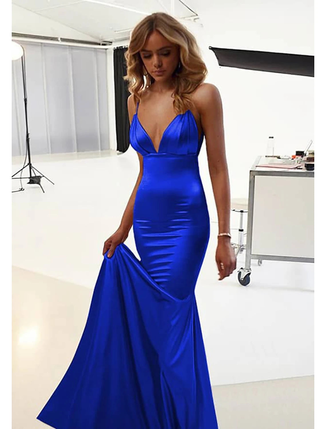 Model wearing an elegant red mermaid trumpet backless ruched floor-length dress.