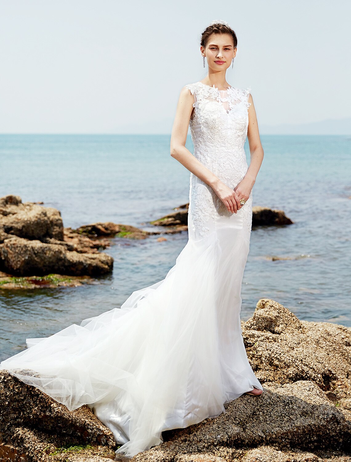 Elegant mermaid trumpet wedding dress with bateau neckline and lace details.