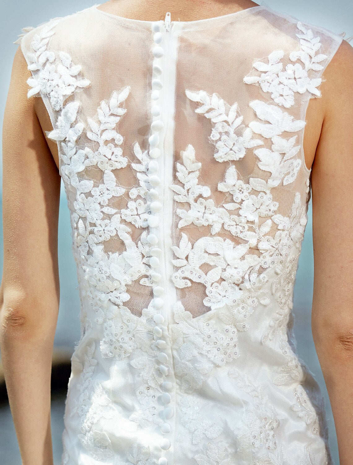 Side profile of a bride wearing a mermaid trumpet lace wedding dress.