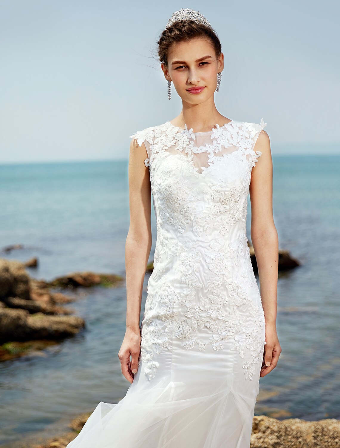 Bride posing gracefully in a ruched lace wedding gown.