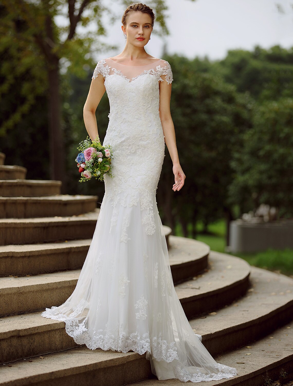 Mermaid trumpet wedding dress with illusion neck and short sleeves.