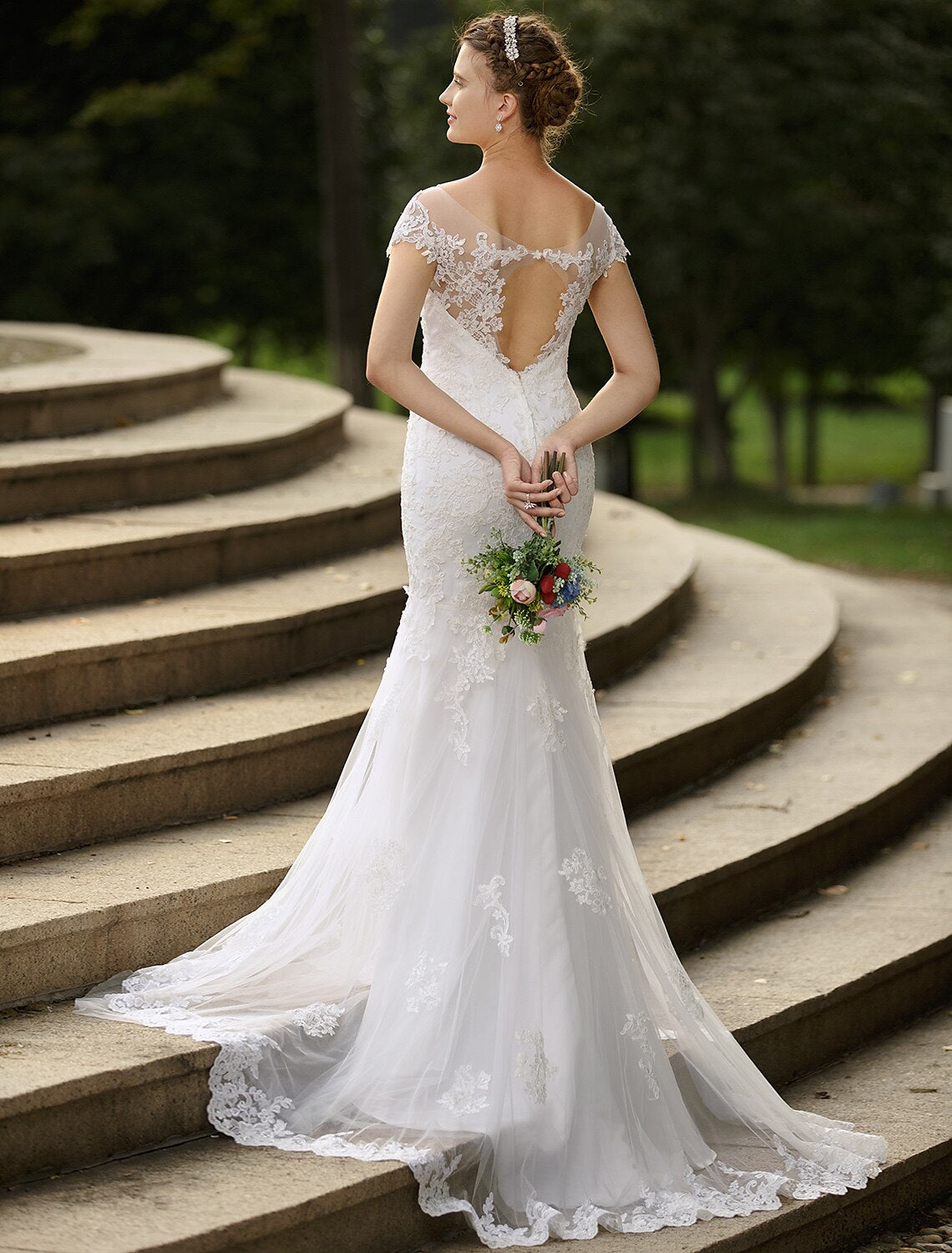 Back view of satin bridal gown with sweep train and appliques.
