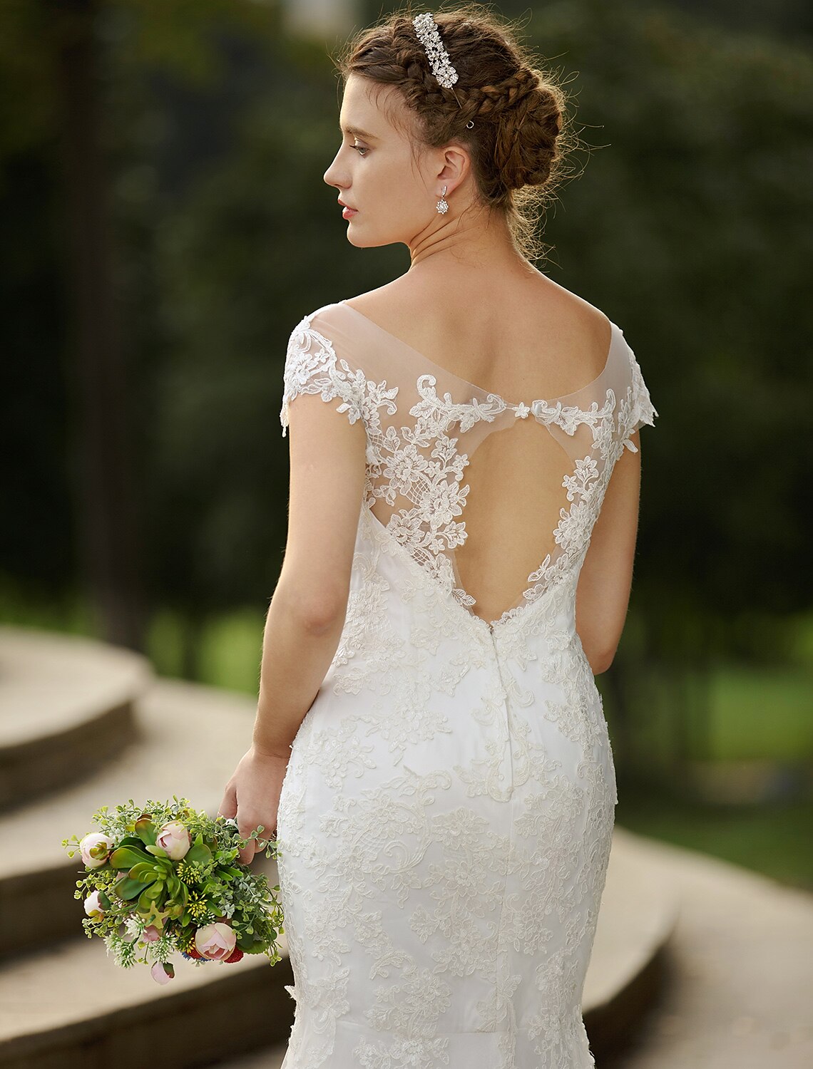 Side profile of elegant wedding dress showing mermaid silhouette.