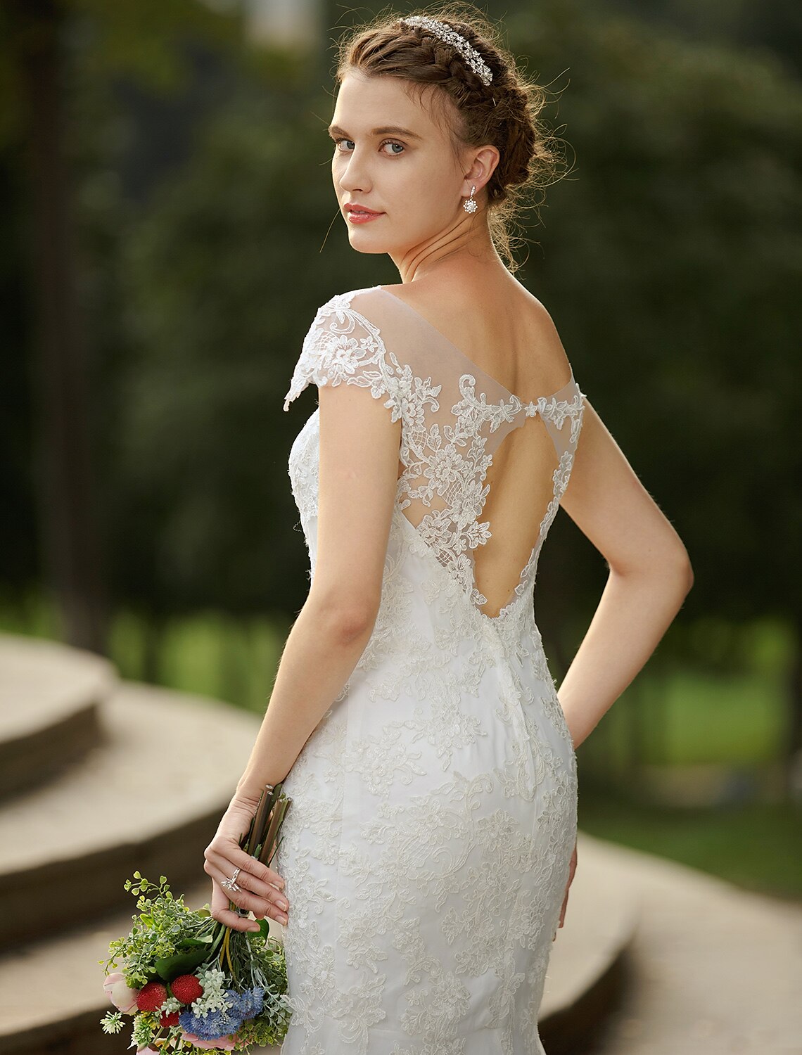 Full length view of satin wedding dress with appliques.
