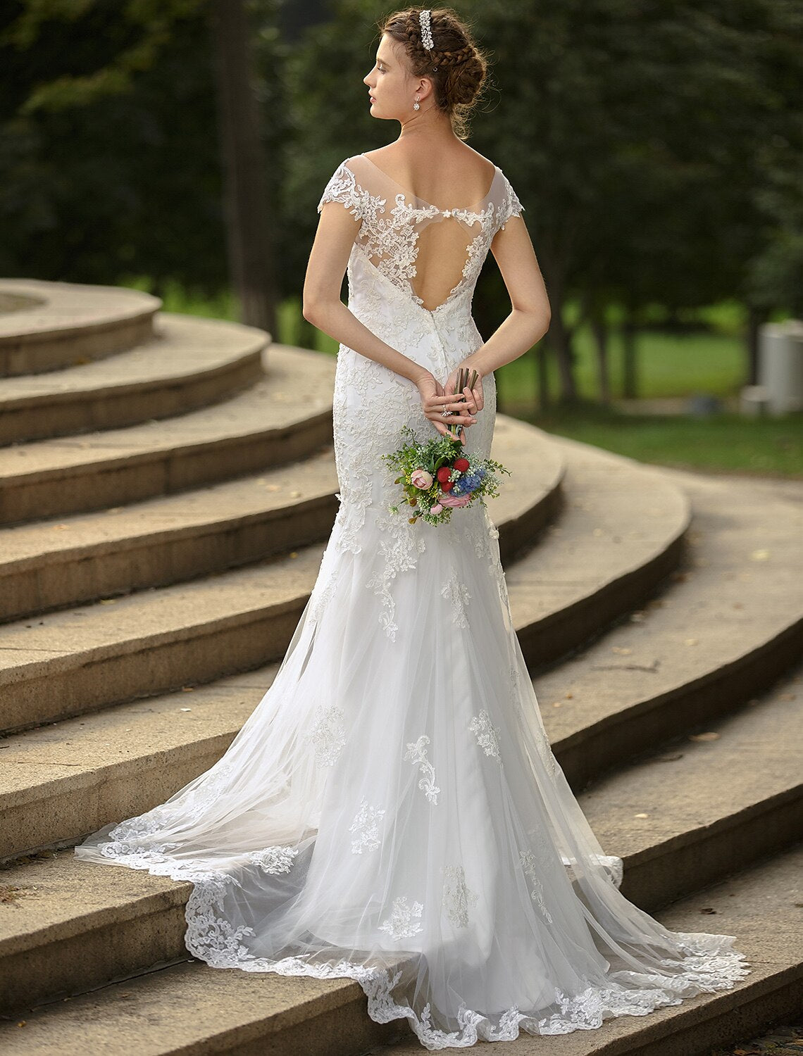 Detailed view of appliques on the satin wedding dress.