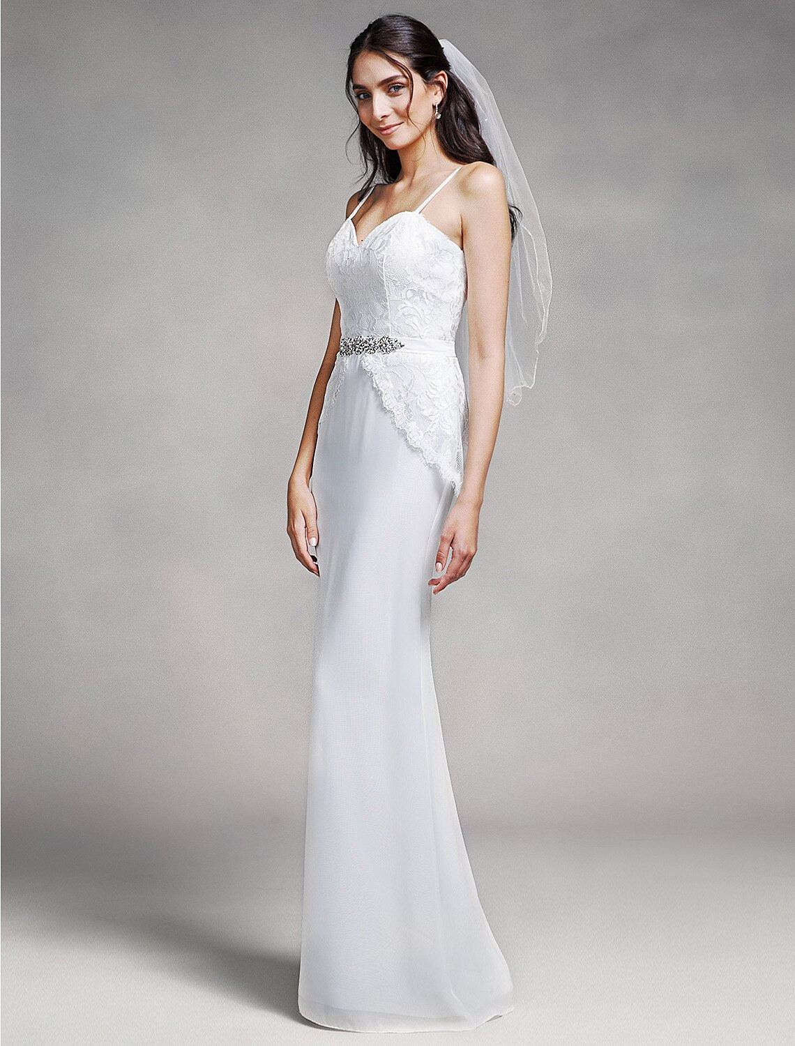 Bridesmaid dress featuring spaghetti straps and crystal embellishments.