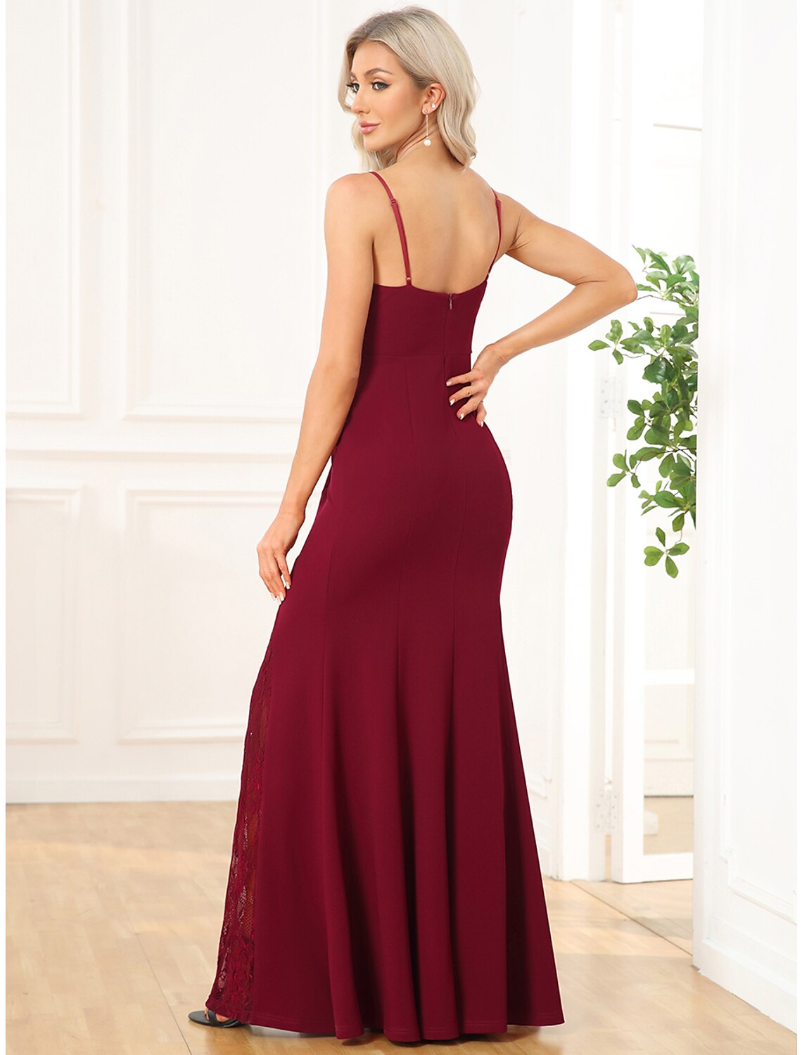 Back view of a sleeveless embroidered floor length prom dress.