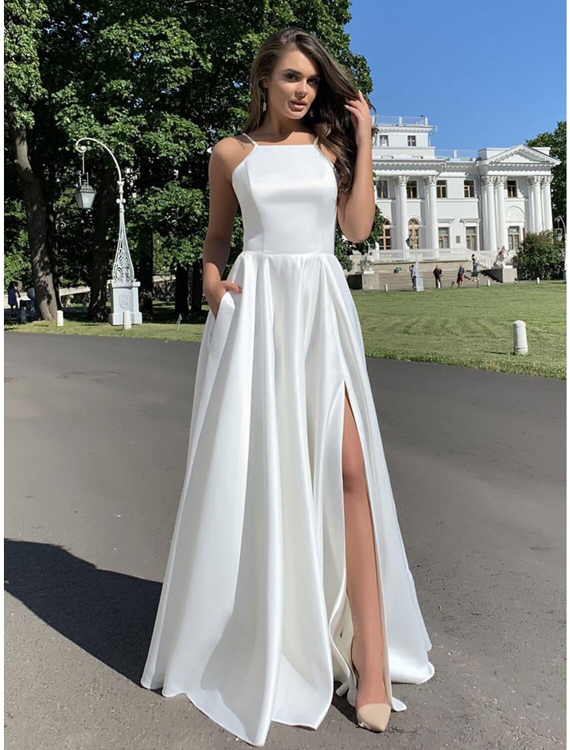 Woman wearing a floor-length mermaid trumpet evening dress.