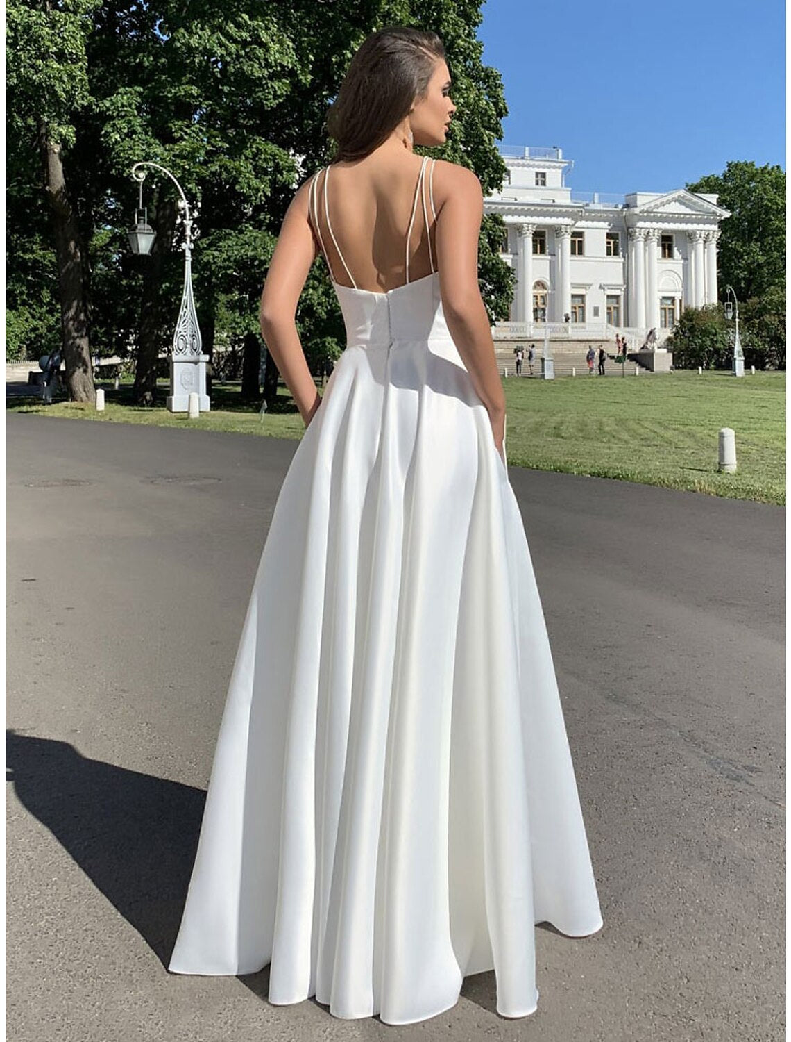 Back view of a mermaid trumpet gown with strappy crisscross detail.