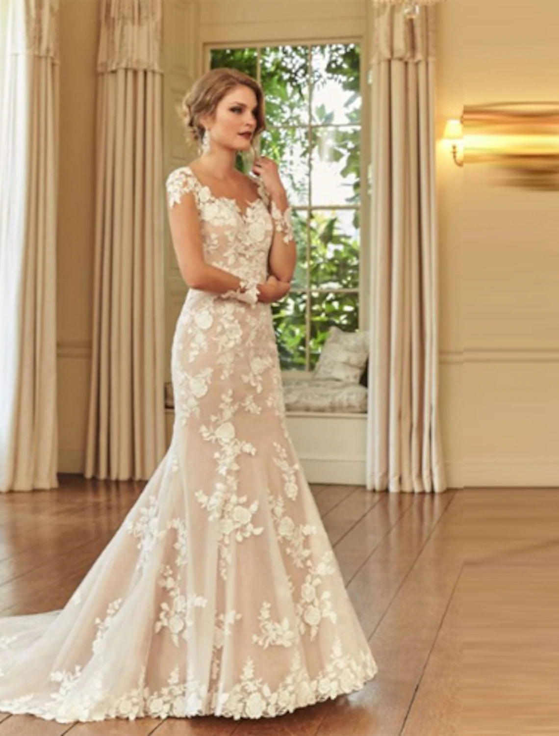 Elegant mermaid trumpet bridal gown with illusion neck and long sleeves.