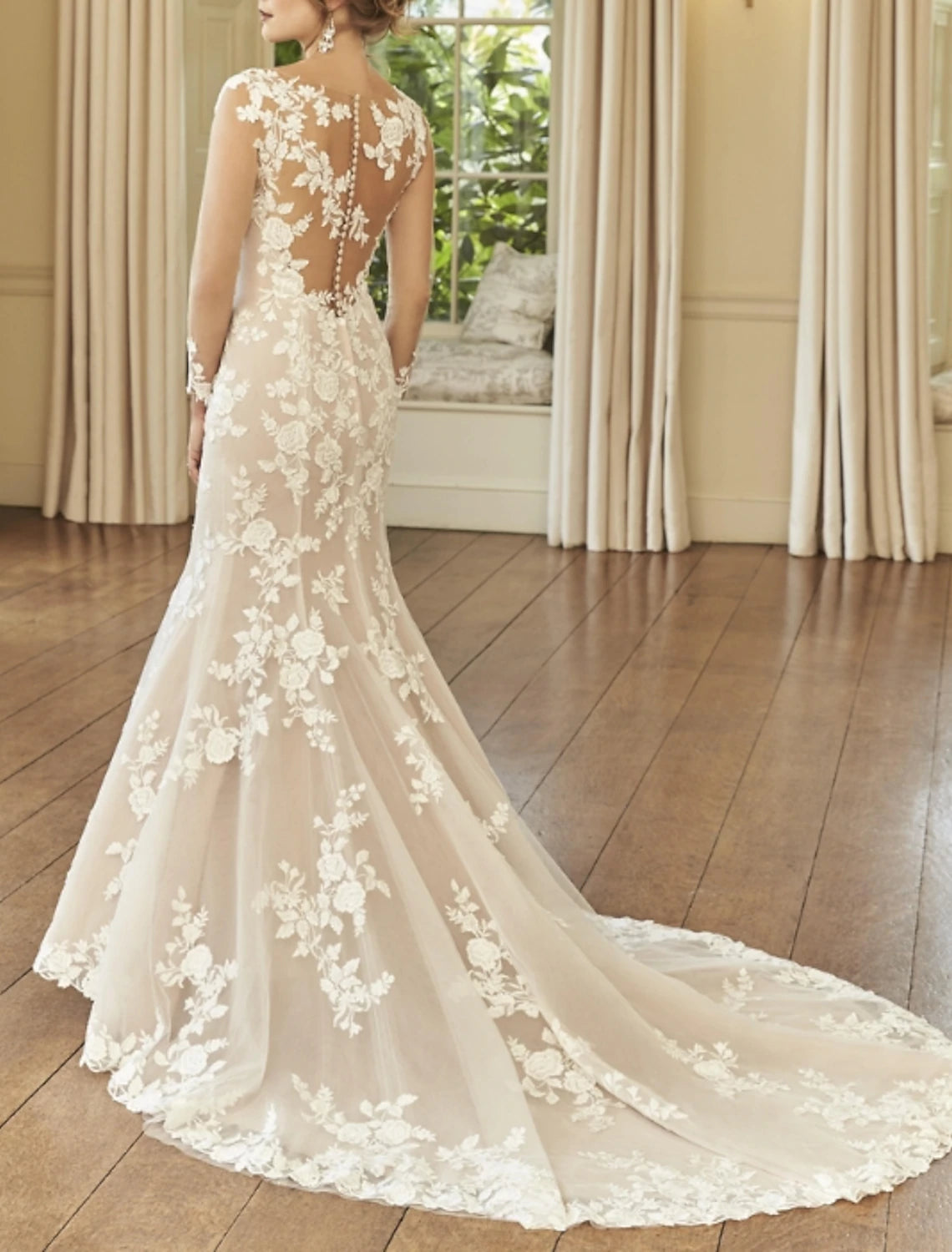 Back view of lace embroidered bridal gown with court train.