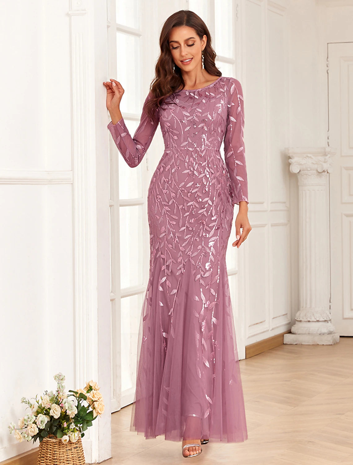 Woman gracefully walking in the long sleeve jewel neck formal dress.