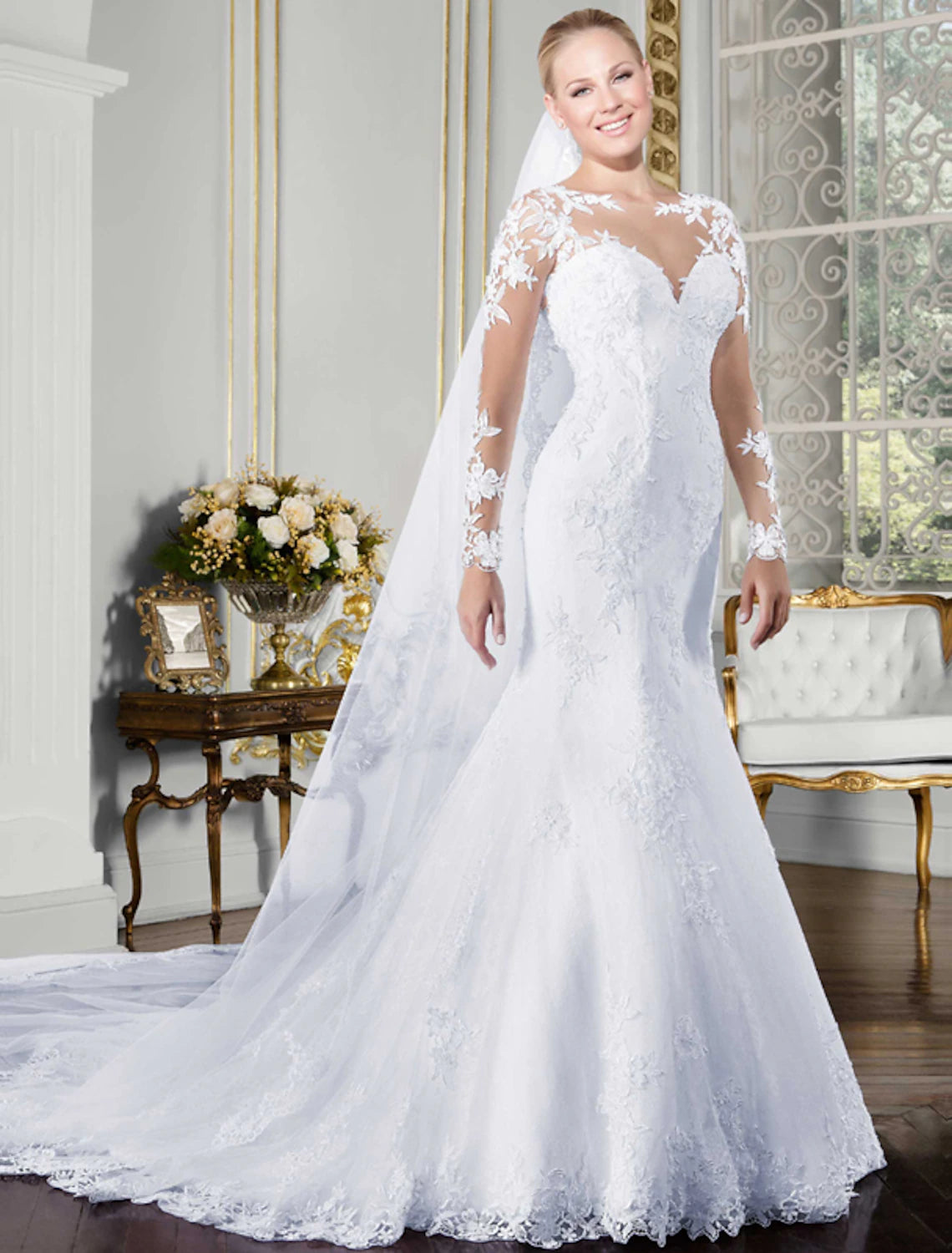 Elegant mermaid trumpet wedding gown with long sleeves and open back.