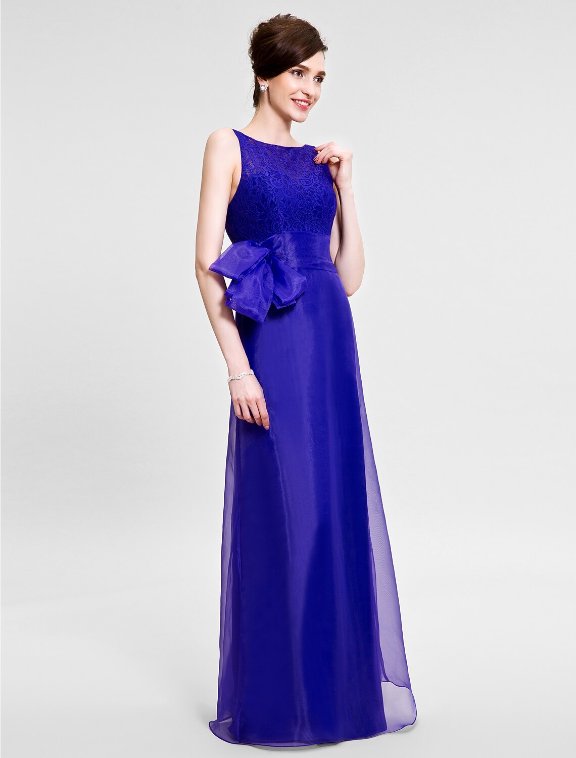 Detailed view of the lace fabric and trumpet flare of the dress.