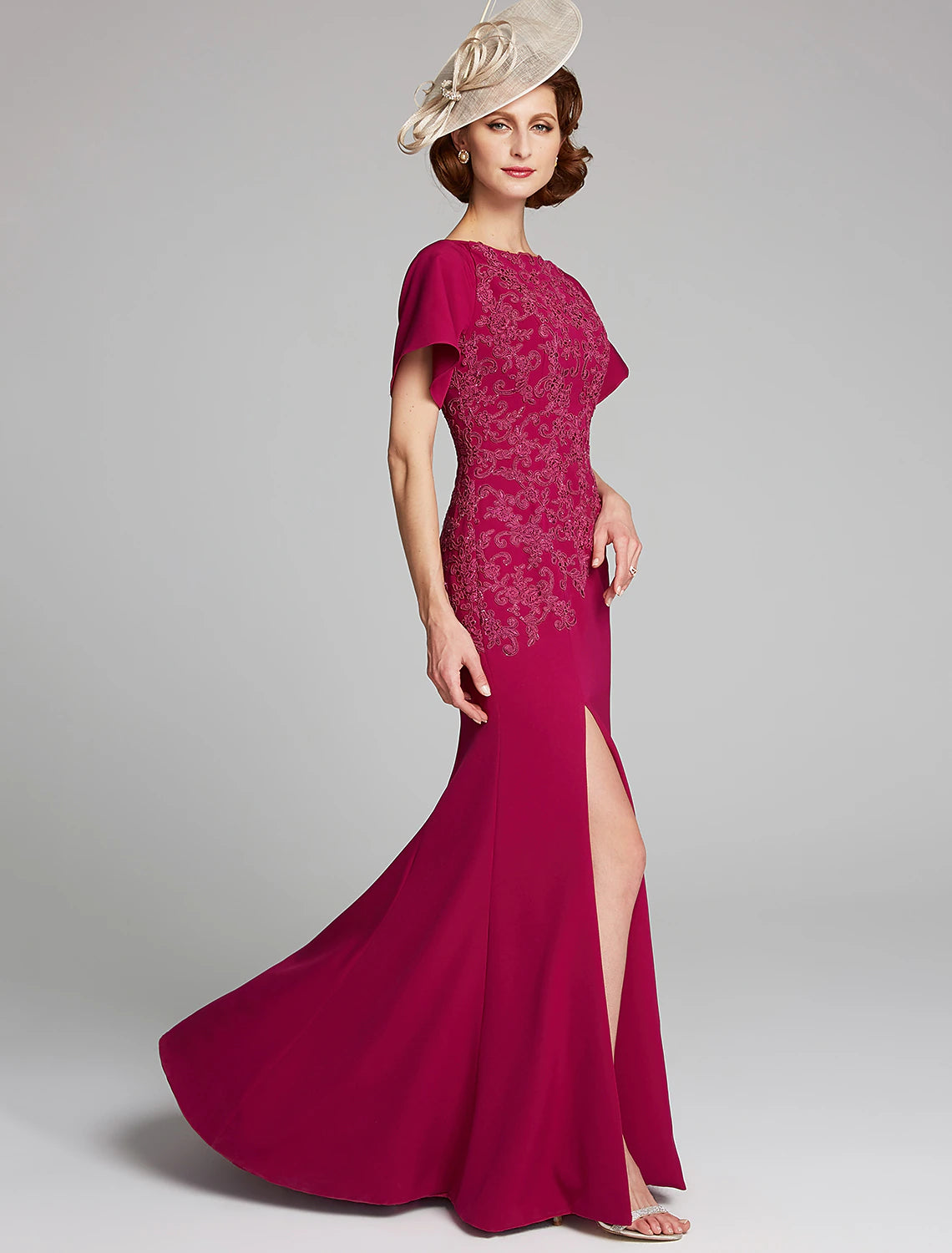 Detail of the bateau neckline and short lace sleeve on the formal dress.