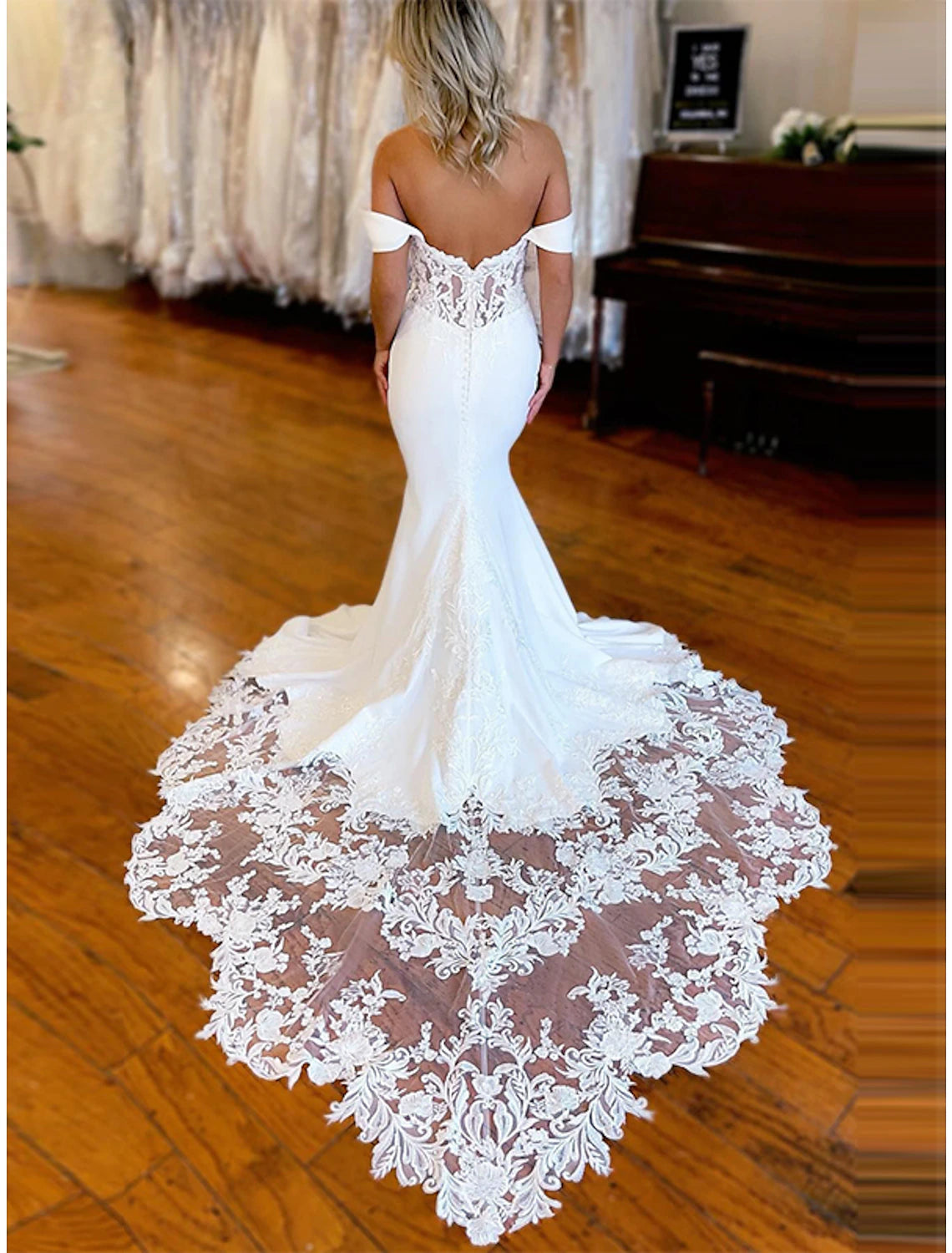 Back view of a mermaid trumpet wedding dress featuring a chapel train.