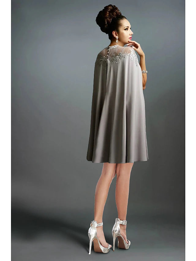 Back view of the knee-length mermaid dress, showcasing ruffle and embroidery accents.